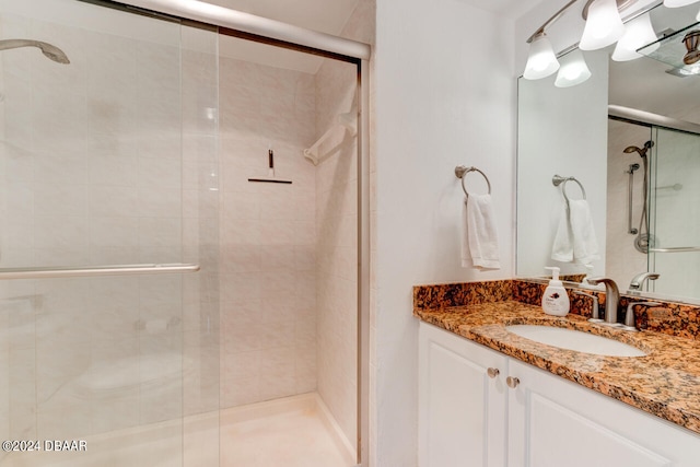 bathroom with walk in shower and vanity