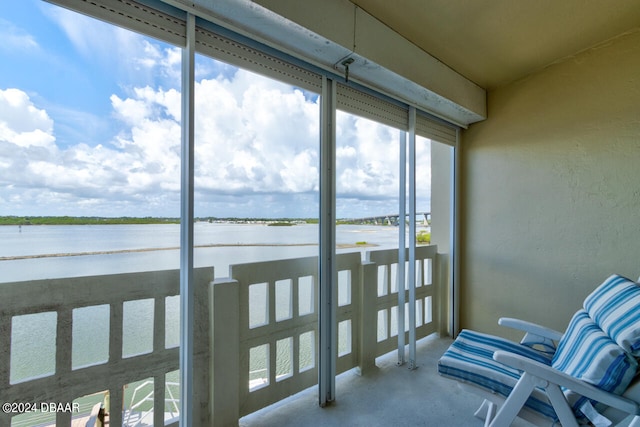 sunroom / solarium with a water view