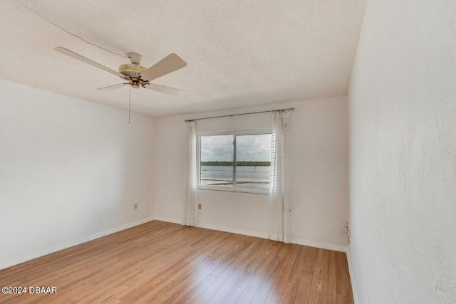 spare room featuring hardwood / wood-style floors, a textured ceiling, and ceiling fan