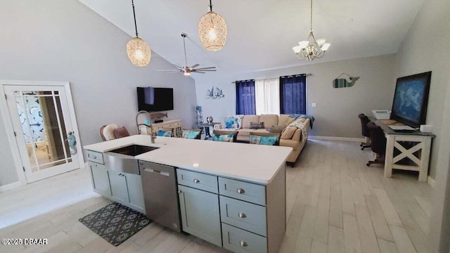 kitchen with a sink, light wood-style floors, pendant lighting, and dishwasher