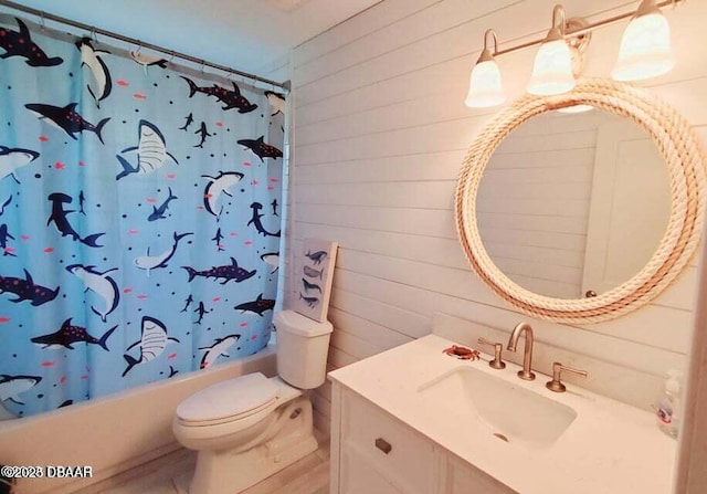 bathroom featuring shower / bath combo, toilet, wooden walls, and vanity