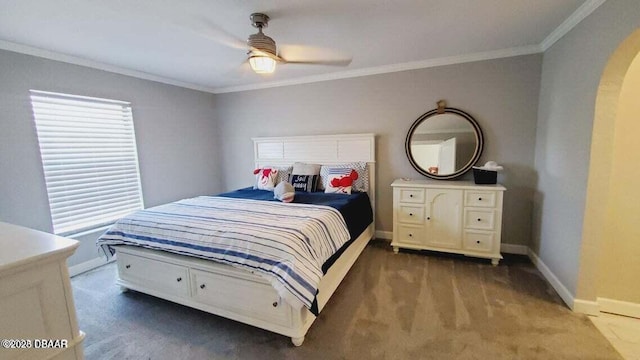 bedroom with arched walkways, carpet floors, a ceiling fan, baseboards, and crown molding