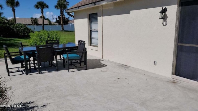 view of patio / terrace featuring fence and outdoor dining space