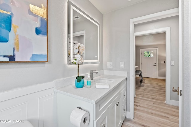 bathroom with vanity and wood-type flooring