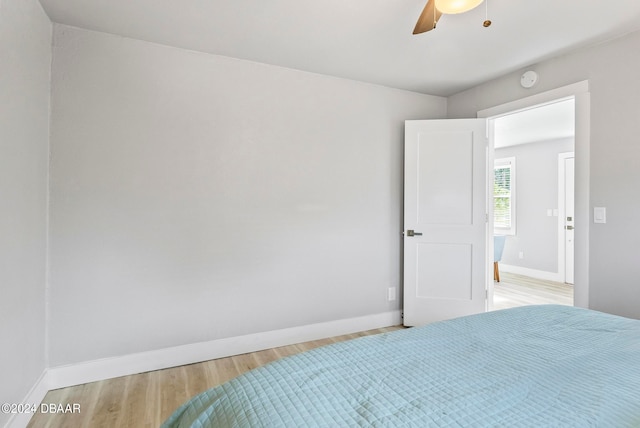 bedroom with light hardwood / wood-style floors and ceiling fan