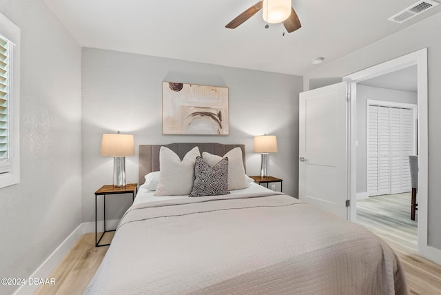 bedroom featuring a closet, ceiling fan, and light hardwood / wood-style floors