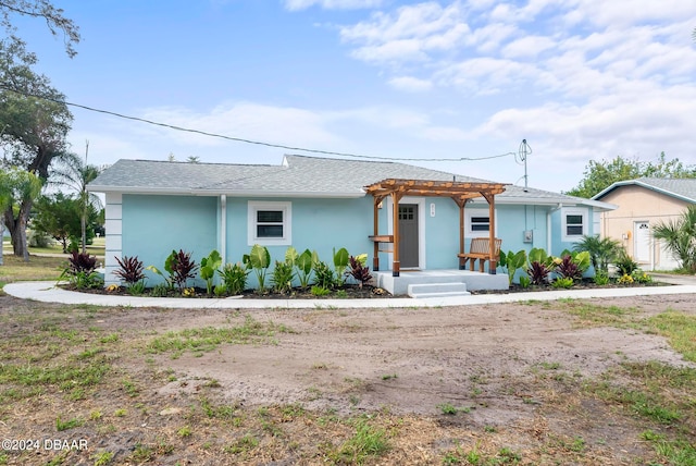 single story home featuring a pergola