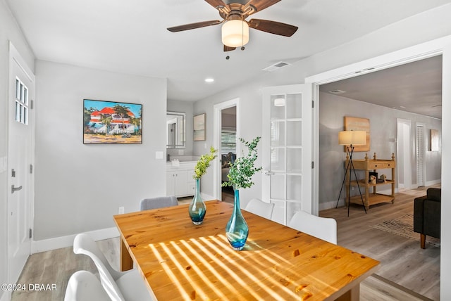 dining room with ceiling fan, plenty of natural light, and light wood-type flooring