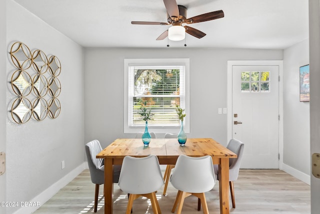 dining room with light wood-type flooring, ceiling fan, and plenty of natural light