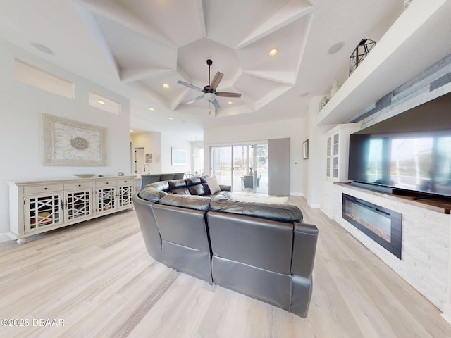 living room with ceiling fan, wood finished floors, a glass covered fireplace, coffered ceiling, and recessed lighting