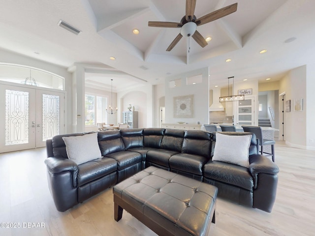 living room featuring french doors, visible vents, light wood-type flooring, ceiling fan with notable chandelier, and recessed lighting