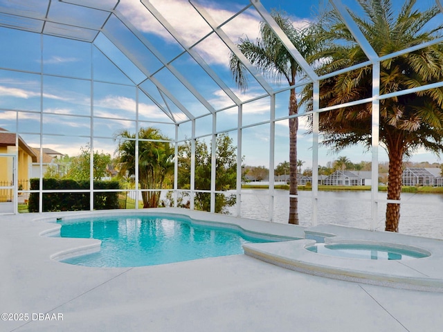 view of pool featuring glass enclosure, a water view, and a patio area