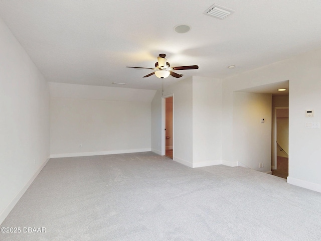 unfurnished room with baseboards, visible vents, a ceiling fan, and light colored carpet