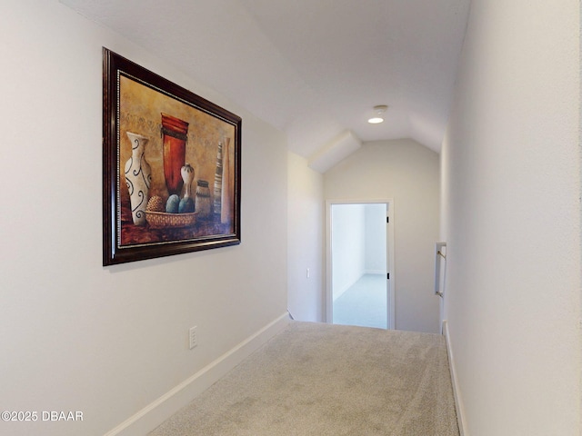 corridor with baseboards, carpet flooring, vaulted ceiling, and recessed lighting