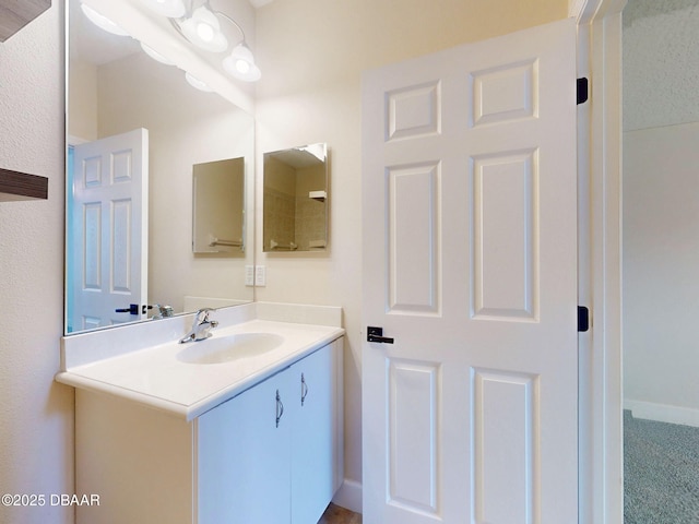 bathroom with vanity and baseboards