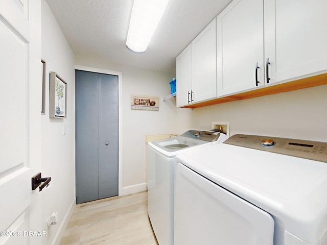 laundry room with separate washer and dryer, cabinet space, light wood finished floors, and baseboards