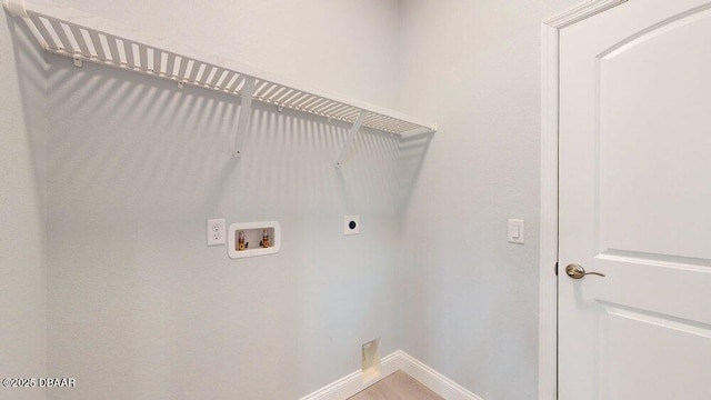 clothes washing area featuring hookup for a washing machine and hookup for an electric dryer