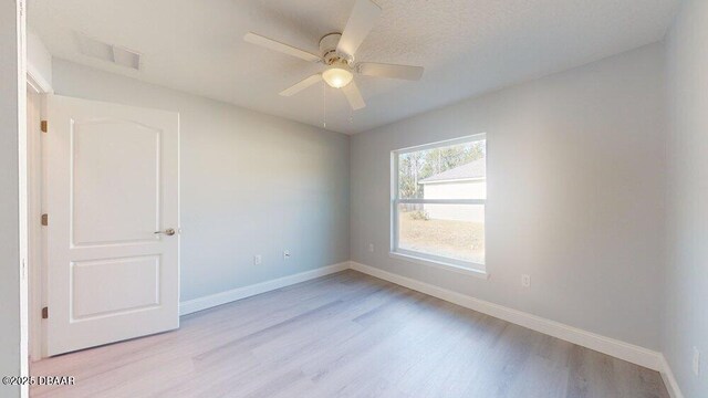 spare room with ceiling fan and light hardwood / wood-style flooring