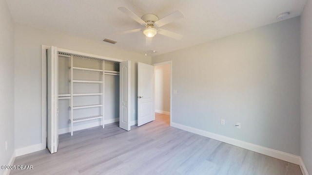 unfurnished bedroom with ceiling fan, light hardwood / wood-style floors, and a closet