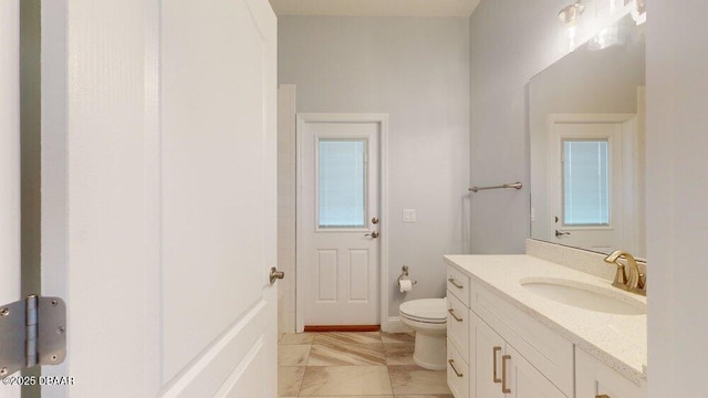 bathroom featuring tile patterned flooring, vanity, and toilet