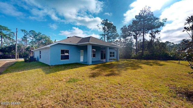 back of house featuring a yard and a patio