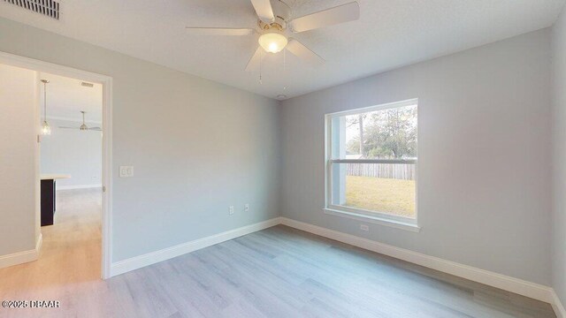 spare room with ceiling fan and light hardwood / wood-style flooring