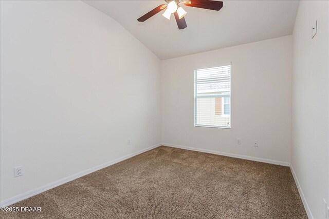 carpeted empty room featuring ceiling fan and vaulted ceiling