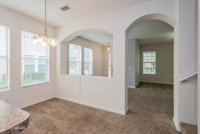 unfurnished dining area with a wealth of natural light and carpet flooring