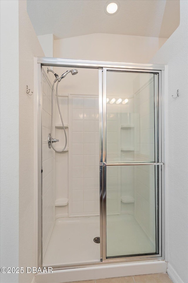 bathroom featuring a shower with shower door