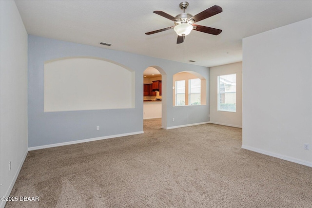 carpeted spare room featuring ceiling fan