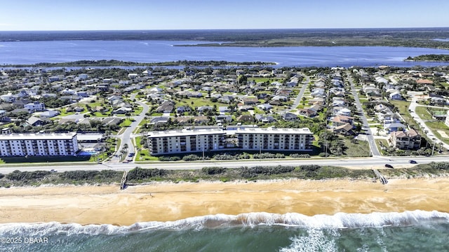 birds eye view of property featuring a water view and a view of the beach