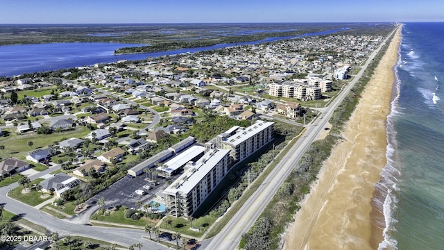 birds eye view of property featuring a beach view and a water view