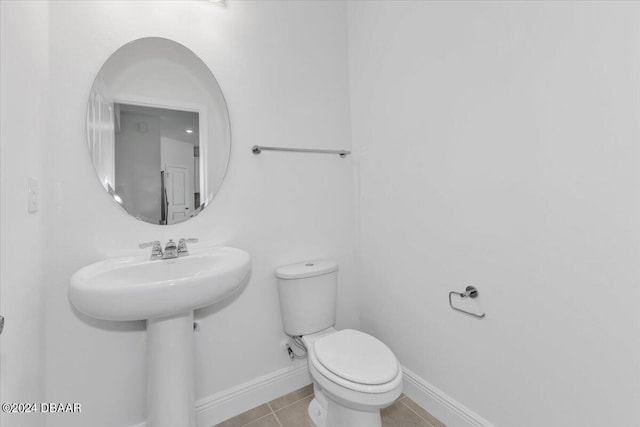 bathroom featuring tile patterned floors, toilet, and sink