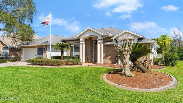 view of front of house featuring a front yard, driveway, and an attached garage