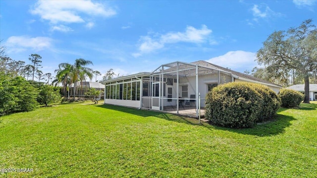 back of house with a lanai and a lawn