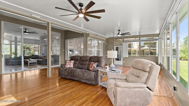 sunroom / solarium with a ceiling fan