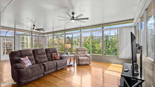 sunroom / solarium featuring ceiling fan and plenty of natural light