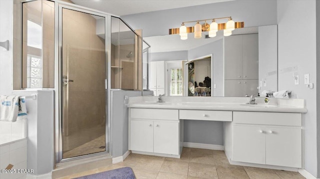 full bath with a sink, a shower stall, tile patterned floors, double vanity, and plenty of natural light