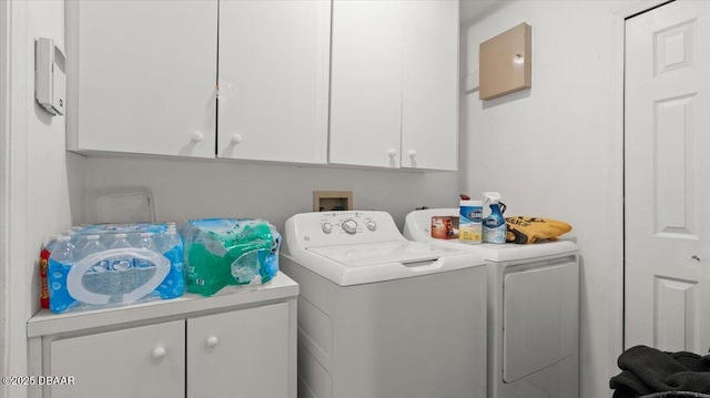 laundry room featuring washing machine and dryer and cabinet space