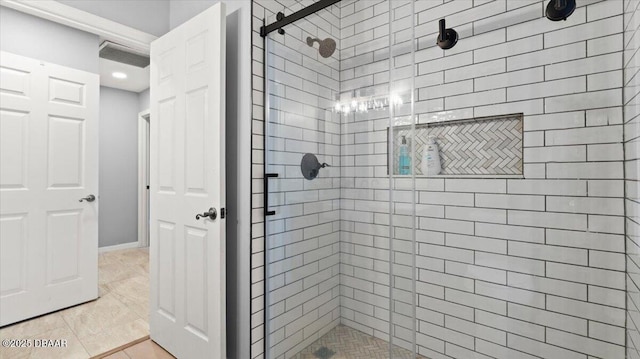 bathroom with a shower stall and tile patterned floors