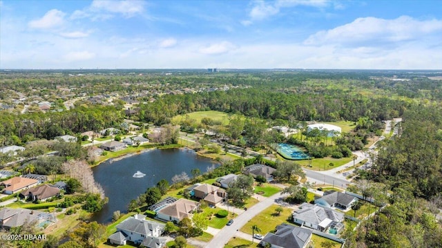 drone / aerial view with a residential view, a water view, and a forest view