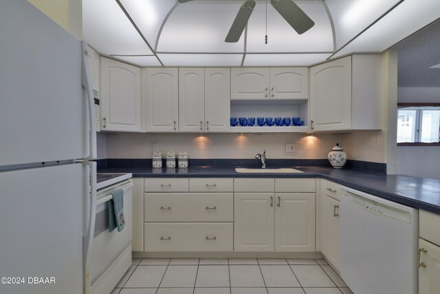 3047 S Atlantic Ave Unit 1206, Daytona Beach, FL 32118 - kitchen with white cabinetry, sink, light tile patterned floors, white appliances, and decorative backsplash
