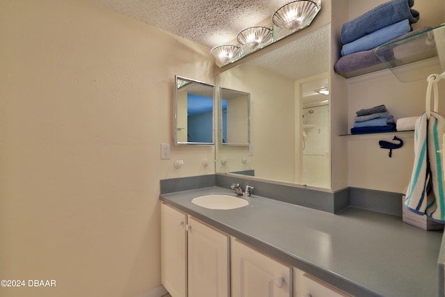 3047 S Atlantic Ave Unit 1206, Daytona Beach, FL 32118 - bathroom featuring vanity and a textured ceiling