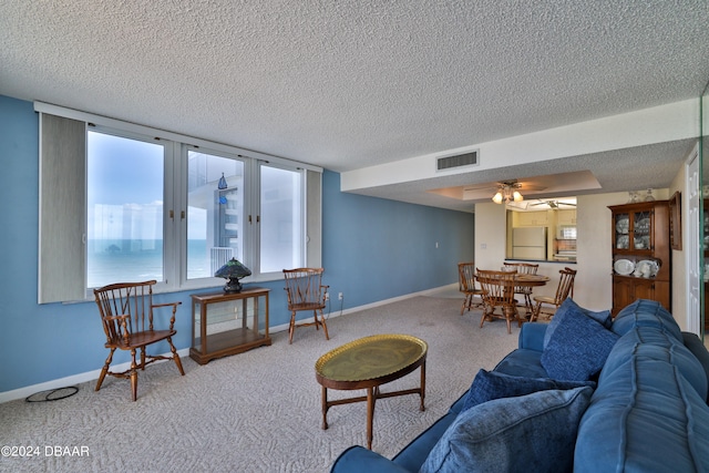 3047 S Atlantic Ave Unit 1206, Daytona Beach, FL 32118 - living room with carpet flooring, a water view, and a textured ceiling