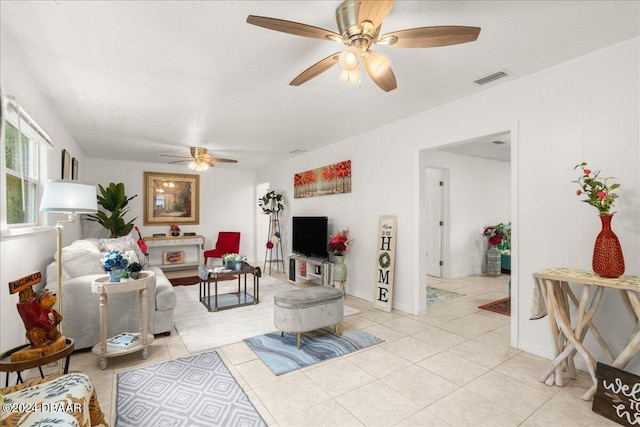 tiled living room featuring a textured ceiling and ceiling fan