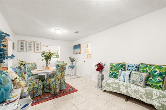 dining room featuring a textured ceiling and light tile patterned flooring