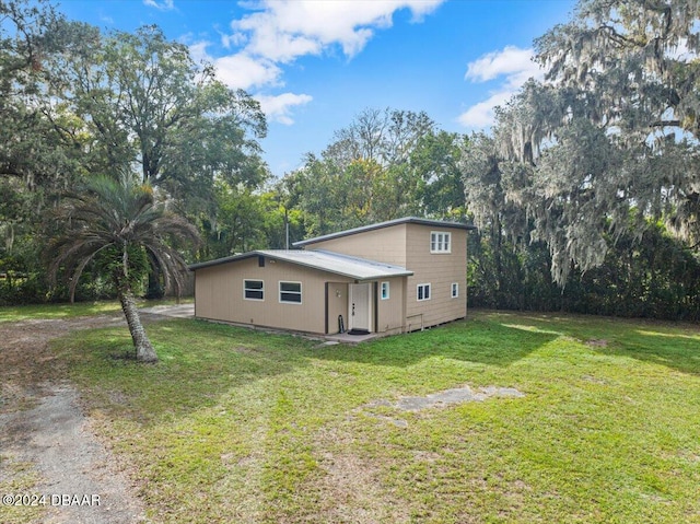 view of side of home featuring a lawn