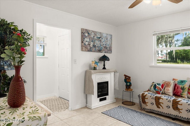 tiled living room featuring ceiling fan and a textured ceiling