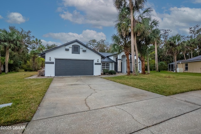 ranch-style house with an attached garage, a front lawn, concrete driveway, and stucco siding