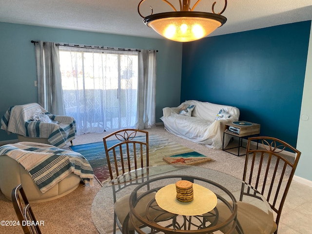 living room featuring a textured ceiling and light carpet